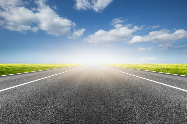 Image of a road with a bright light at the end