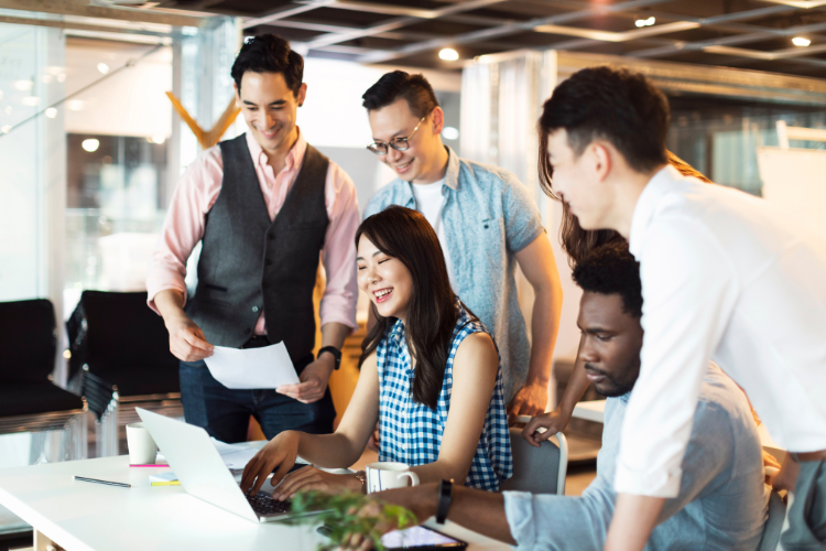 A group of corporate employees smiling at work