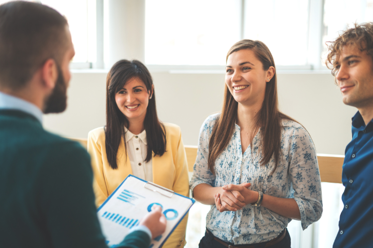 Employees listening to a performance report