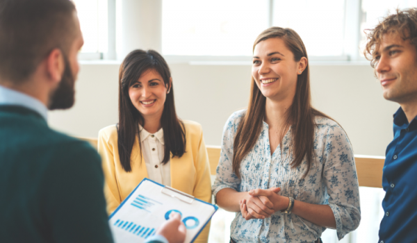 Employees listening to a performance report